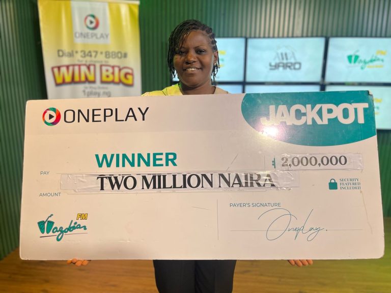 Confidence holding her ₦2 Million check from Oneplay