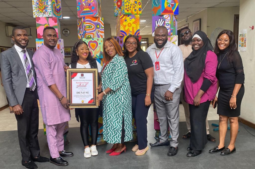Oneplay team receiving the Humanitarian Service Award from the Sickle Cell Foundation Nigeria, recognizing their impact and contributions.